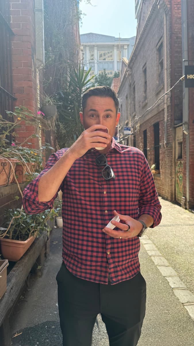 Gabe drinking coffee in a Melbourne laneway